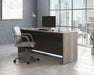 Teknik Affiliate 1800600 Desk in a Hudson Elm effect finish two grommet holes for cord management