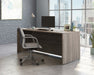 Teknik Affiliate 1800750 Desk in a Hudson Elm effect finish two grommet holes for cord management