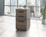 Teknik Affiliate 3 Drawer Mobile Pedestal in a Hudson Elm effect finish, two small drawers, one larger spacious filer lockable drawer
